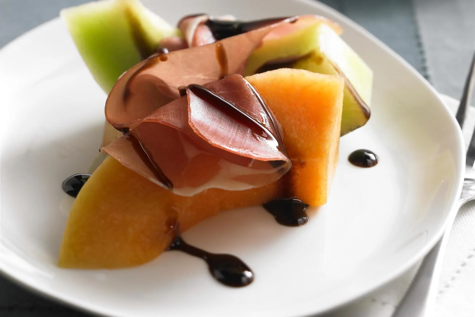 Melon and Prosciutto with Ruby Cranberry Drizzle